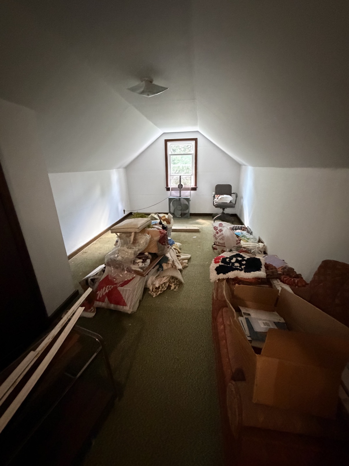 Attic before cleanout — packed with junk